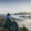 Photographer working with used camera gear and editing software, showing how to make money with photography using budget-friendly tools.