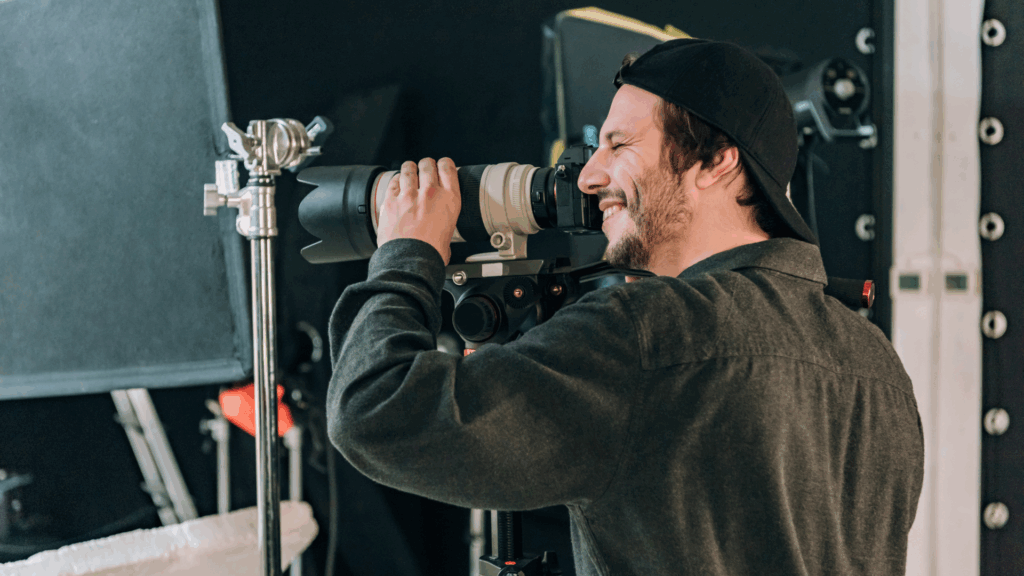 A solo filmmaker adjusting his camera setup on set, reflecting the kind of creator who might use the Canon EOS C50.