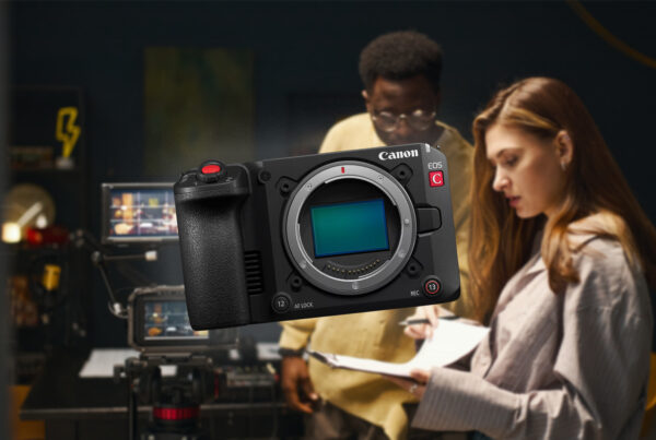 A group of filmmakers setting up cameras and lighting on set, representing creators who could benefit from the Canon EOS C50.