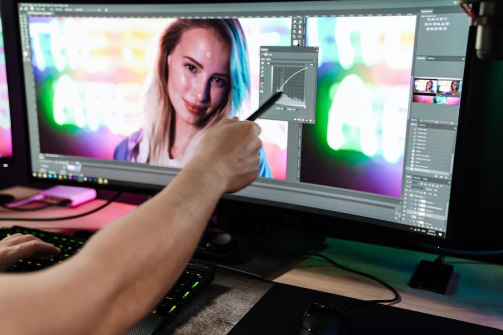 Photographer editing images on Photoshop, demonstrating Mastering Natural Light through post-processing to enhance mood and detail.