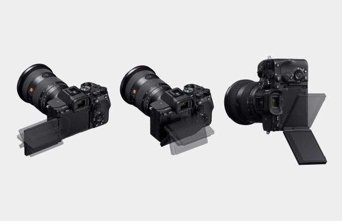 Three Sony A7 V bodies shown from the rear, each displaying their new articulating screens tilted at different angles.