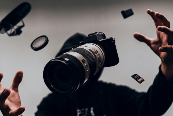 Camera and accessories suspended midair around a creator, symbolizing how cameras are finally built for real work as integrated systems.