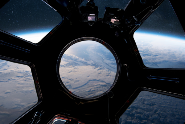 View from the ISS cupola window looking down at Earth — the same vantage point where an astronaut fell in love with photography while orbiting 250 miles above the surface