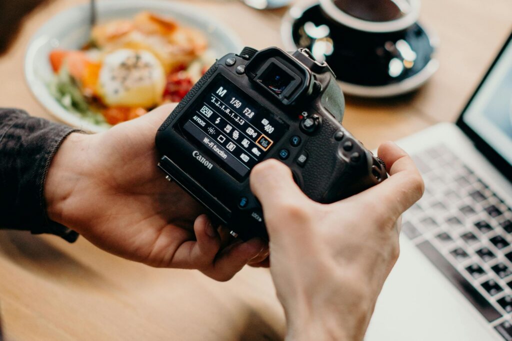 Photographer editing and reviewing images late at work, a common sign of photography burnout in the creator economy