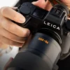 Leica SL3-P review: photographer's hands holding the black SL3-P with a 70-200mm f/2.8 lens attached