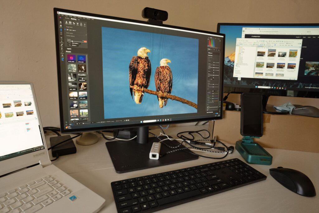 BenQ Photo Monitor on a color-managed editing desk with a photographer reviewing skin tones in a wedding gallery