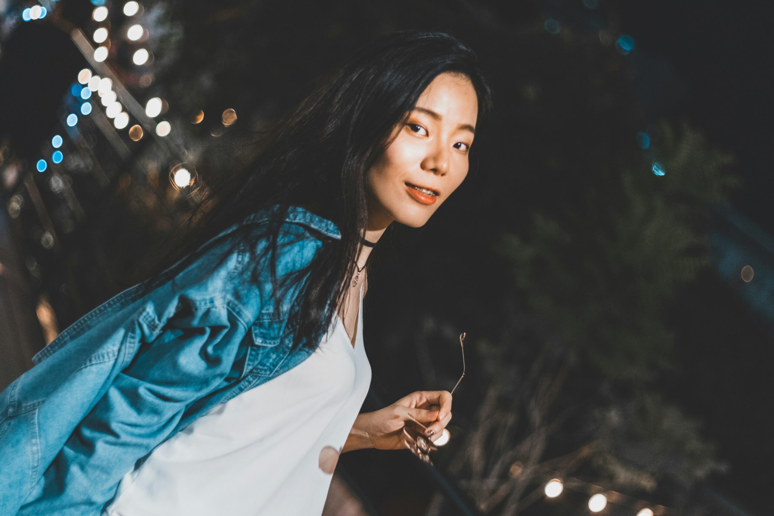 paused film frame with warm-lit face against cool teal background