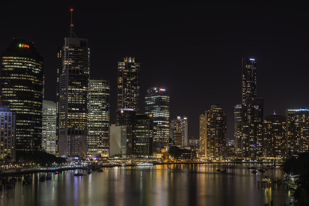Brisbane city skyline illuminated at night with reflections on the river