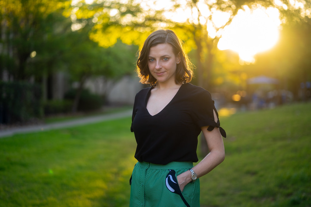 woman in a park at sunset with a soft blurred golden-hour background