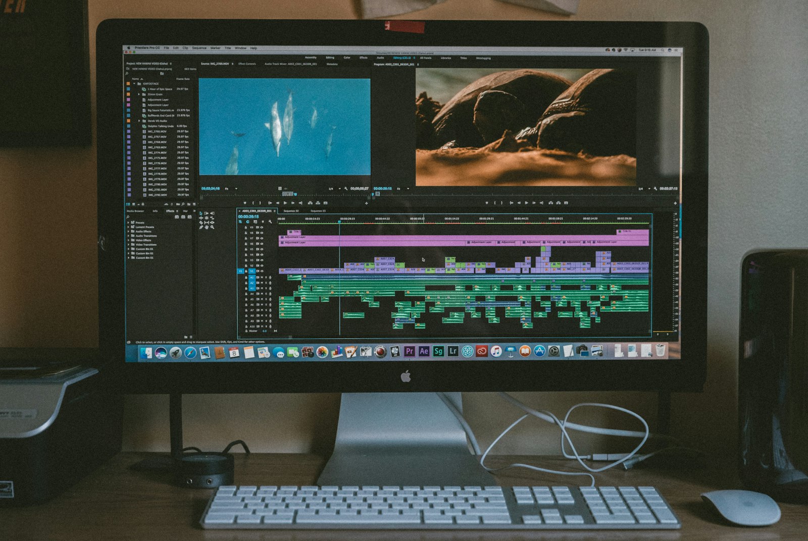desktop monitor displaying editing software with image thumbnails on a workstation desk